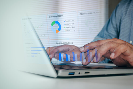 Close up of business professional hands typing on laptop computer with digital business sales dashboard and performance analytics interface overlay, concept of data reporting and analysis.