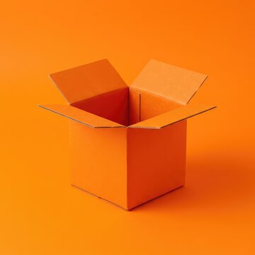 A square, vibrant orange cardboard box sits open on a matching bright orange seamless background, creating a bold, monochrome composition, object, box, flat