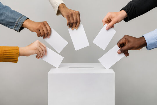 Voting box with multiple hands dropping ballots symbolizing democratic participation civic engagement community decision making and voter turnout concept