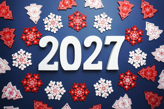 Happy New Year 2027 alphabet letter with Christmas decoration on blue background