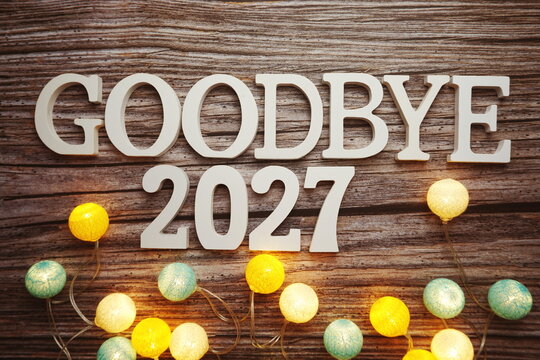 Goodbye 2027 alphabet letter with cotton ball LED decoration on wooden background