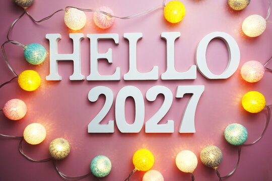 Hello 2027 alphabet letter with cotton ball LED decoration on pink background