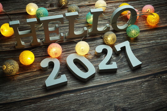 Hello 2027 alphabet letter with cotton ball LED decoration on wooden background