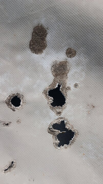 Damaged plastic sheet texture with melted burned holes
