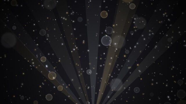 Abstract dark background with golden sparkling particles and light rays, representing a festive or magical atmosphere
