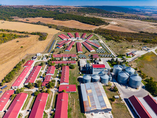 Aerial view of an agricultural complex with grain silos and farm buildings in a rural landscape © DSMT