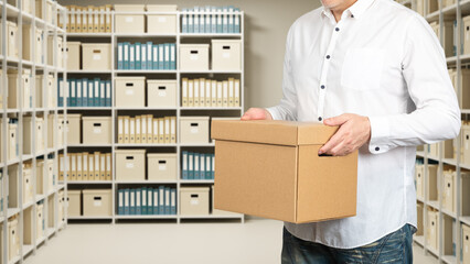 Document archive logistics, employee carries a storage box while organizing files, records and...