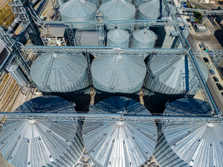 Aerial view of grain silos and conveyor structures at an agricultural storage facility during daylight © DSMT