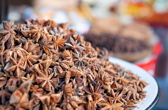 Star anise spice heap display. Organic brown aromatic ingredient market pile
