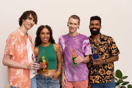 Diverse friends share a colorful toast at a joyful modern party