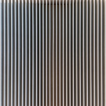 Heat sink fins with a brushed aluminium texture and amber glow, featuring hard shadows for hardware and engineering backgrounds