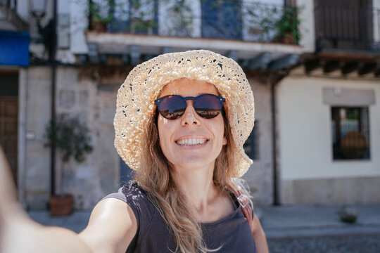 Confident European Female Over 40 Taking a Sunny Selfie in a Small Spanish Town