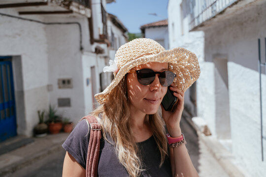 Freckled European in Her Forties Talking on Smartphone in a Sunny Spanish Village