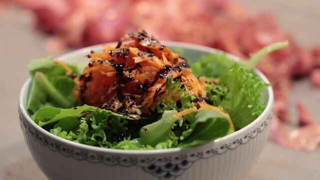 Stockholm, Sweden A tossed salad in a bowl with carrots and balsamic vinegar.