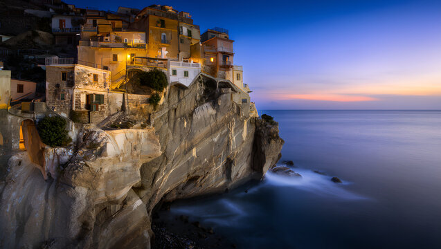 Manarola village on the cliffside of Cinque Terre during a beautiful twilight.