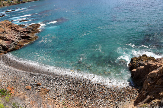 Scenic Rocky Coastal Cove and Turquoise Ocean Water with Pebble Beach in Ensenada.