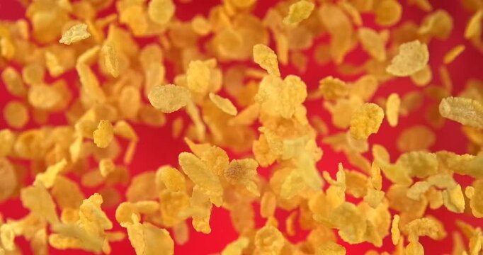 Corn flakes falling in slow motion 1000 fps on red background