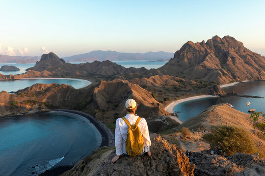 Young female tourist enjoying the beautiful landscape at Padar island in Komodo National Park, Indonesia