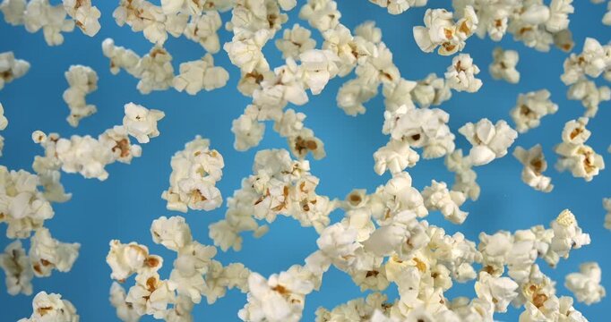 Popcorn falling in slow motion 1000 fps on blue background