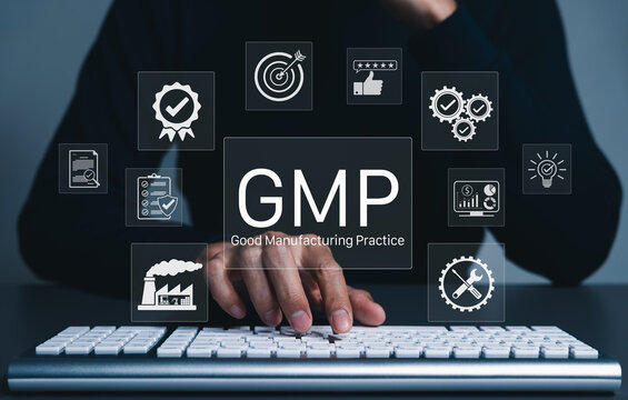 GMP Good Manufacturing Practice Concept. Businessman typing on keyboard with icons representing compliance, quality control, assurance, certification, factory standards, certified process management
