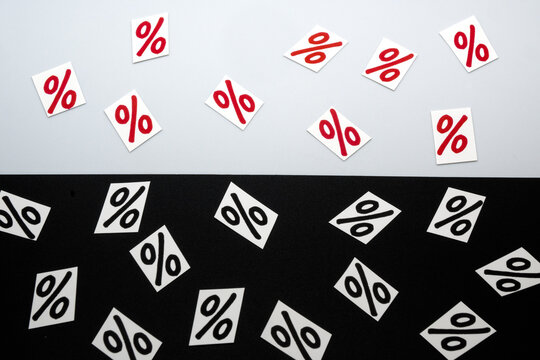 Percent symbol on a black-and-white background. Loss or profit in business.

