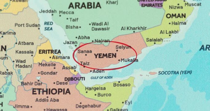 Detailed view of a red circle marking to yemen on a modern political world map