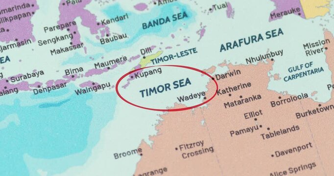 Detailed view of a red circle marking the timor sea region on a modern political world map