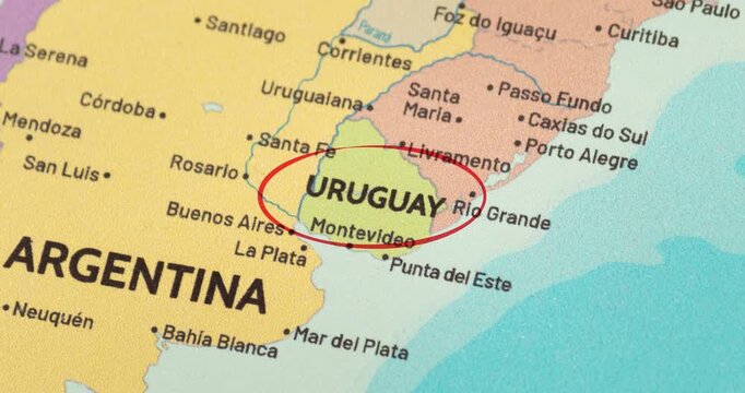 Detailed view of a red circle marking to uruguay on a modern political world map