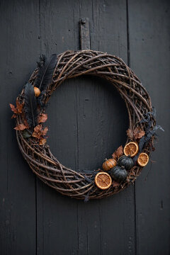 Handcrafted willow wreath with gothic accents and intricate twig texture, ideal for fall decorating inspiration and Halloween craft marketing.