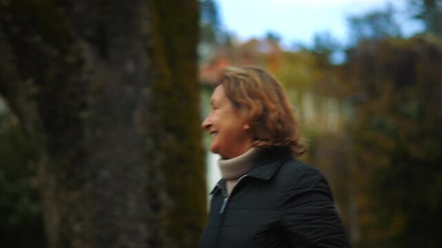 Smiling Caucasian elderly woman looking around her neighborhood