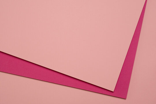 Abstract pink paper background with geometric layers and copy space, minimalist composition in contrasting pink shades