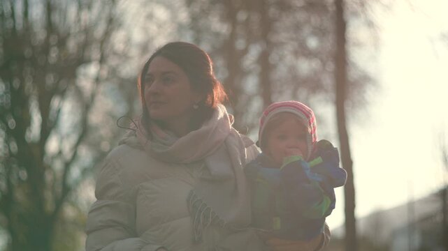 Caucasian mother and toddler bathed in soft winter sunlight