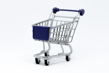 Small metal shopping cart with blue plastic parts on clean white background supermarket miniature © Sajida