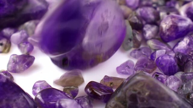 Purple and violet amethyst stone crystals and gems falling down close up