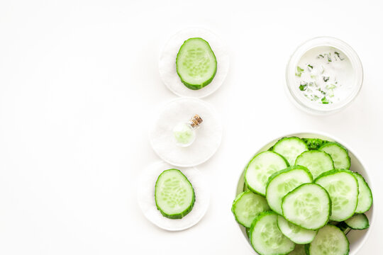 Sliced cucumber for face mask on white background top view copyspace