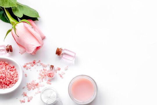 Natural cosmetic with rose oil on white background top view copyspace