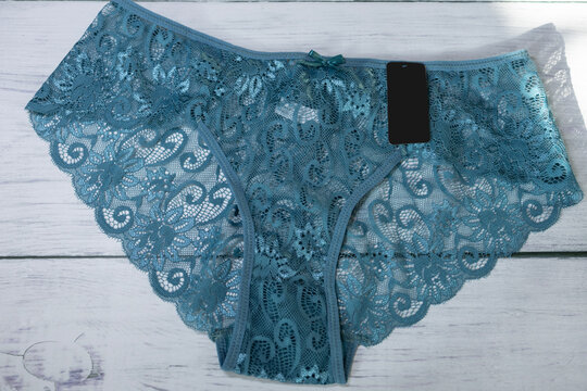 High angle view of female lace panties set in textured background, eco mmerce lingerie product photography