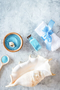 spa cosmetic set with sea salt for bath and shell on stone background top view mockup