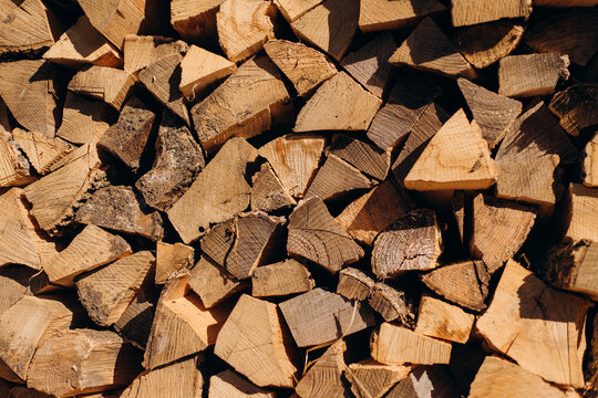 Split firewood stacked for heating and biomass fuel