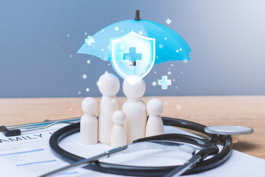Wooden family figures under digital umbrella shield with stethoscope and insurance application form. Health insurance, family protection or medical coverage concept.