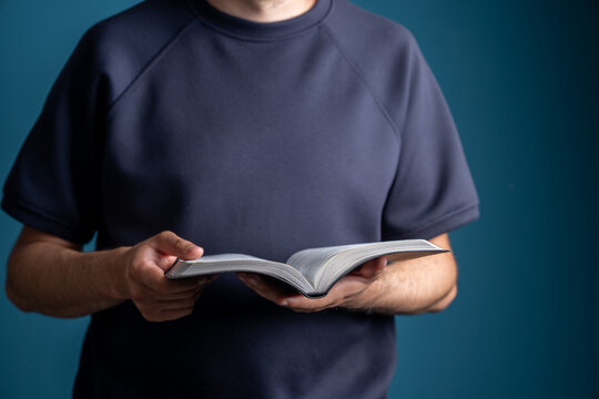 A person is holding an open sacred scripture.