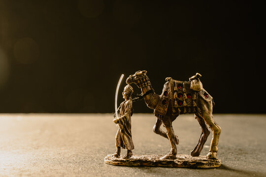 A figurine of a camel with a man