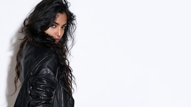 A indian grunge girl with an indifferent, cynical expression, wearing a leather jacket, isolated on a white bakcground