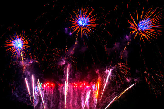 Purple firework in night time celebrate national holiday. Purple Firework celebrate anniversary happy new year 2027, 4th of july holiday festival. Violet firework Countdown to new year 2026 festival