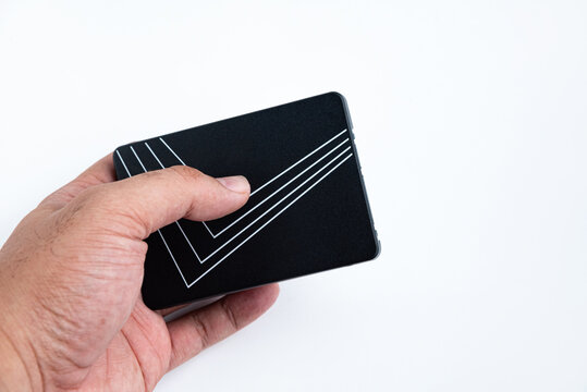 Hand holds black solid state drive