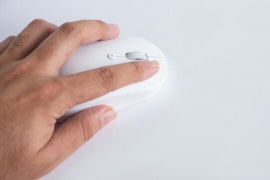 Close up of hand using a white computer mouse
