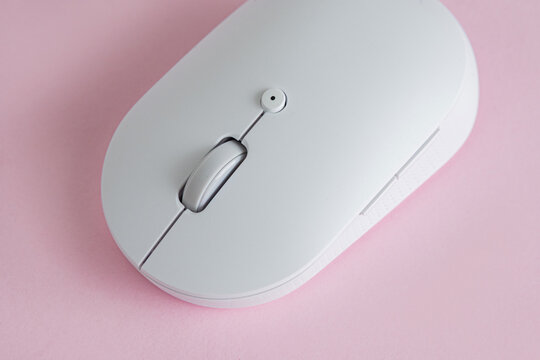 Minimalist white computer mouse on pink
