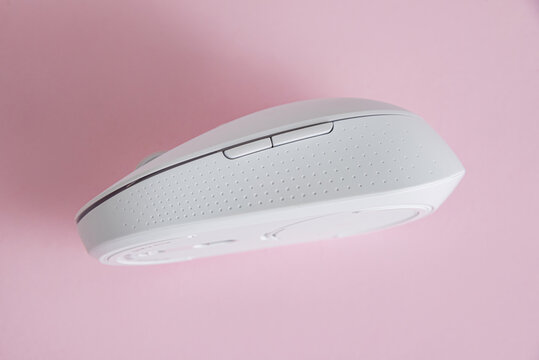 Modern computer mouse on pink background