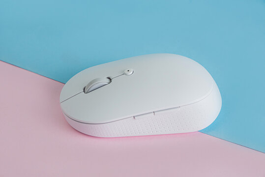 White wireless computer mouse on desk
