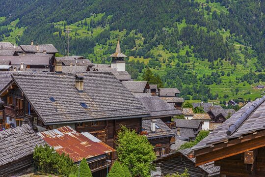 Old houses with wooden shingle roofs, Saint Theodule church at the back, historic village centre, Grimentz, Val d'Anniviers, Valais Alps, Canton Valais, Switzerland
